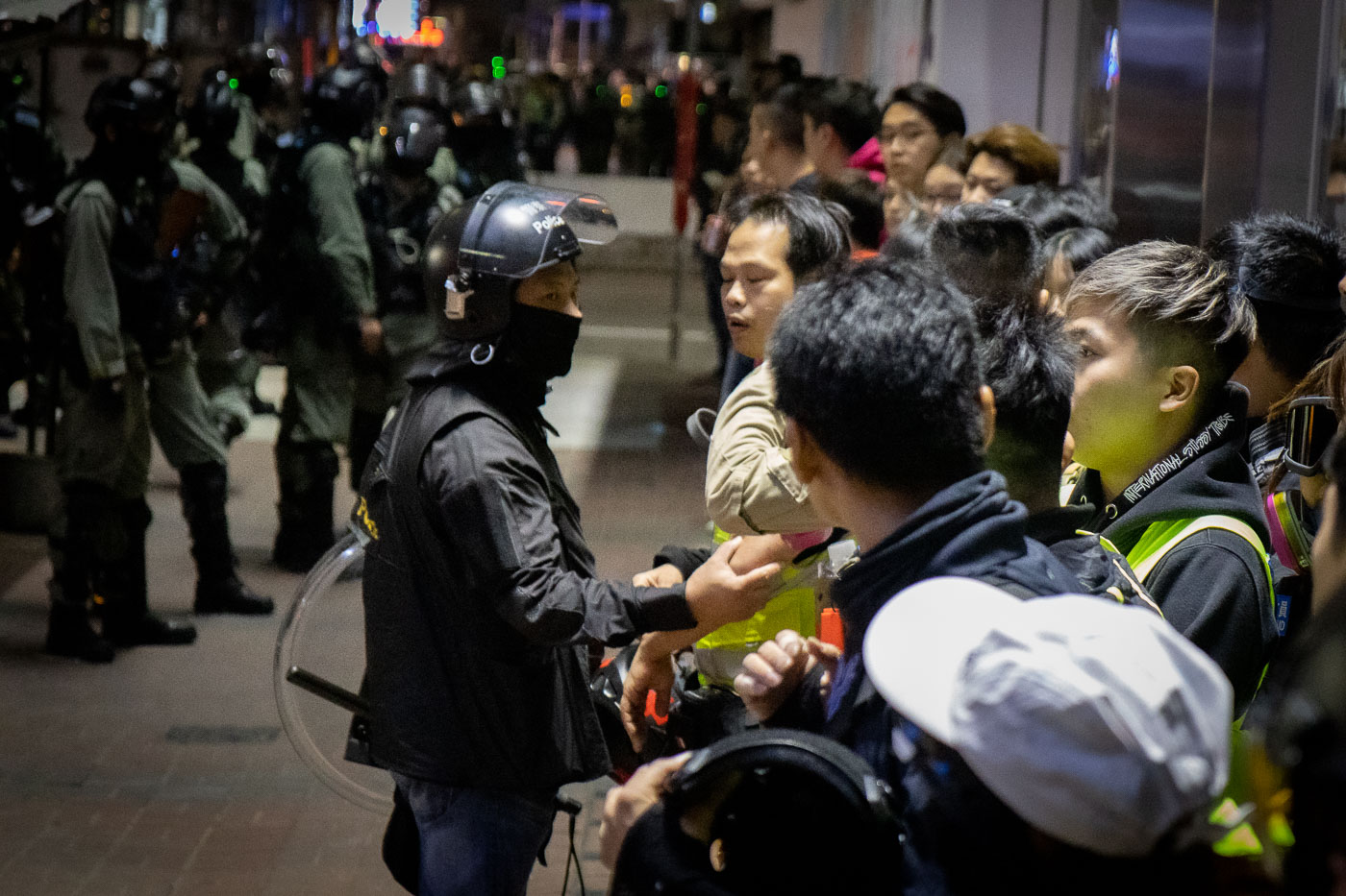 Citizens detained by Hong Kong Police being lined up against a wall.